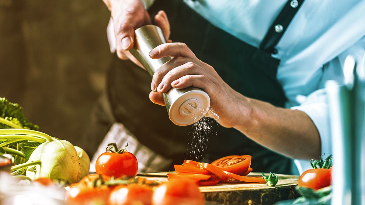 Chef salting on food at a restaurant