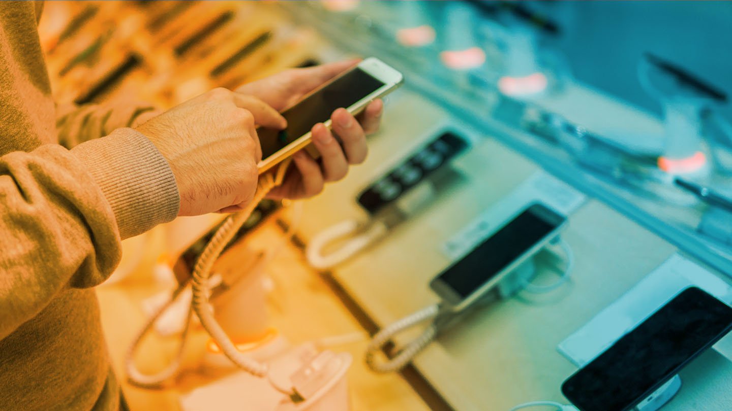 person looking at phones at wireless retail store