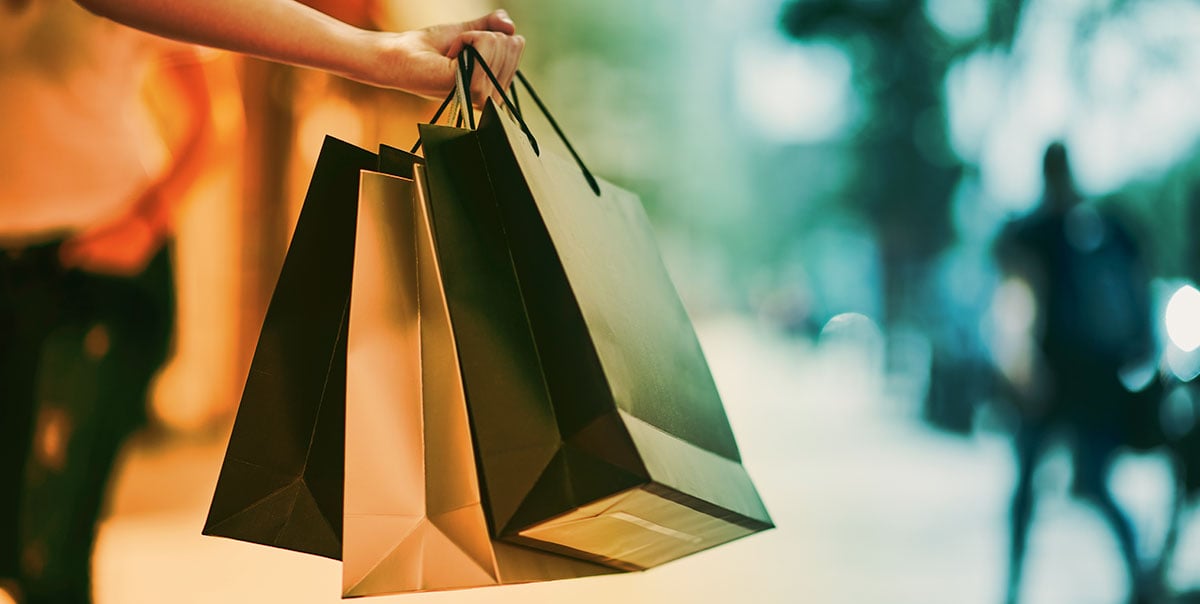 shopper holding bags from purchases