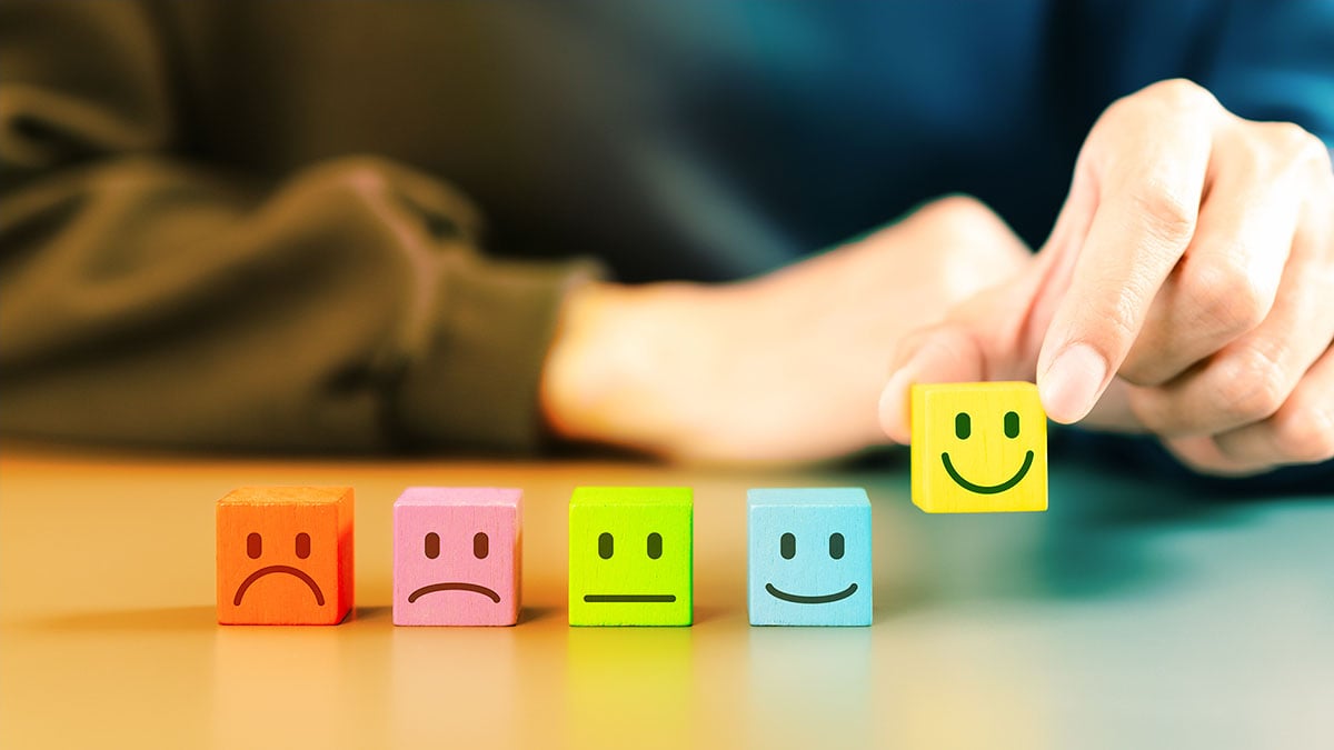 blocks with unsatisfied to satisfied smiley faces on them