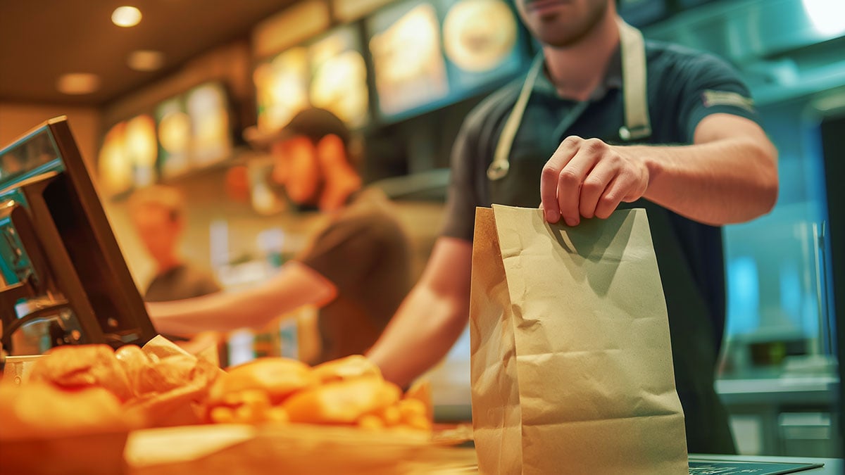 employee handing customer their order