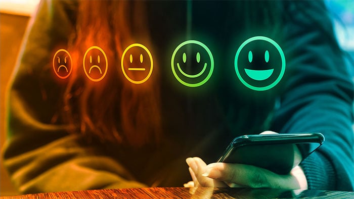 person holding smartphone with satisfaction rating