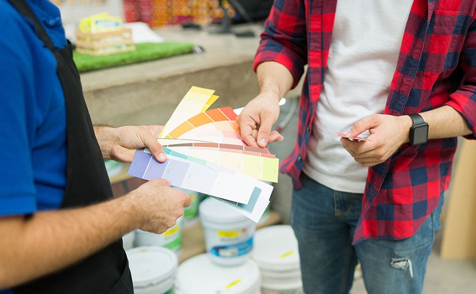looking at paint swatches at a home improvement store