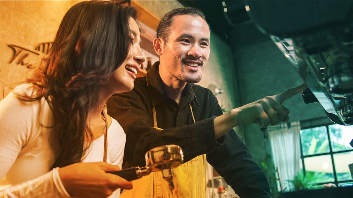 employee being trained at a coffee shop