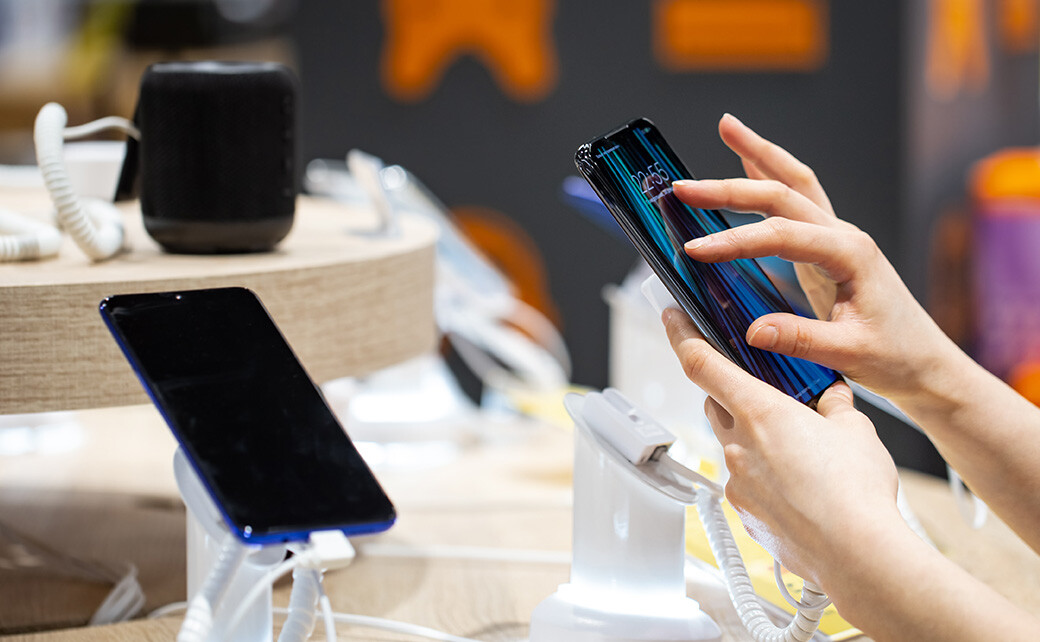 looking at a smartphone in the store